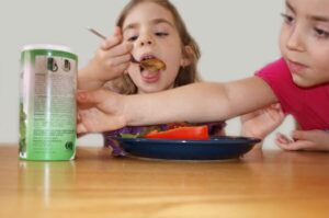 reaching across table
